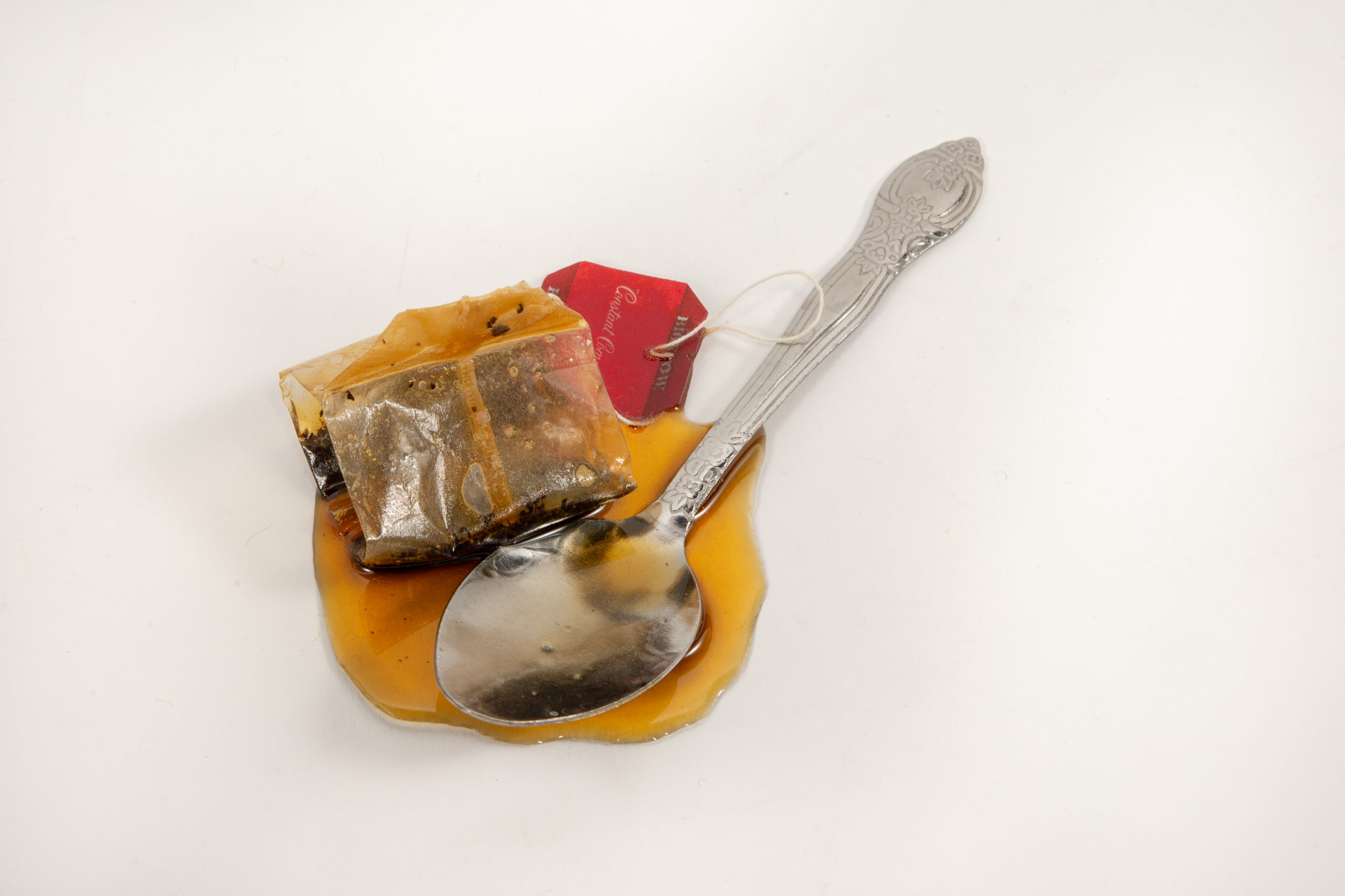 Tea Spoon and Tea Bag in Fake Spill